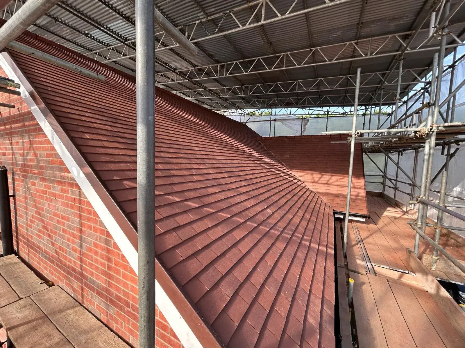 a view of a roof with a red tile on it